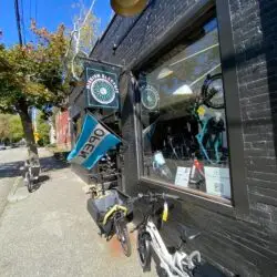 Mission Electric storefront with the OPEN flag out