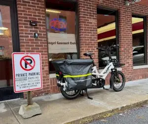 Cargo bike parked outside a bagel shop