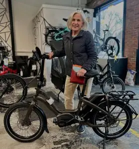 A customer with her new e-bike at Mission Electric